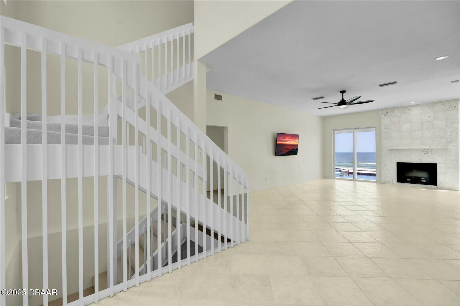 4363 South Atlantic Avenue Ponce Inlet, FL 32127 - Photo 10 of 46 a view of livingroom with fireplace stairs and windows