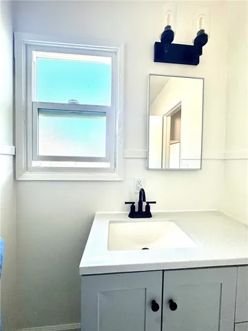 a bathroom with a sink and a window