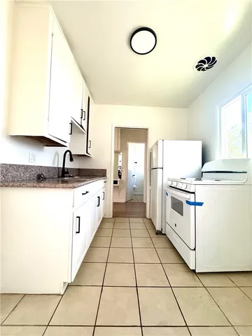 a kitchen with stainless steel appliances a sink and a refrigerator