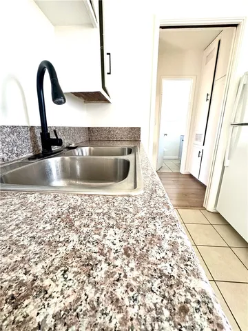 a view of a kitchen with a sink and wooden floor