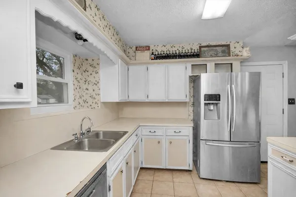 a kitchen with stainless steel appliances white cabinets and a sink