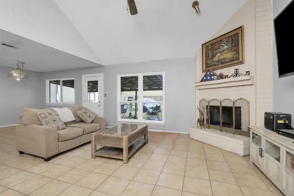a living room with furniture and a fireplace