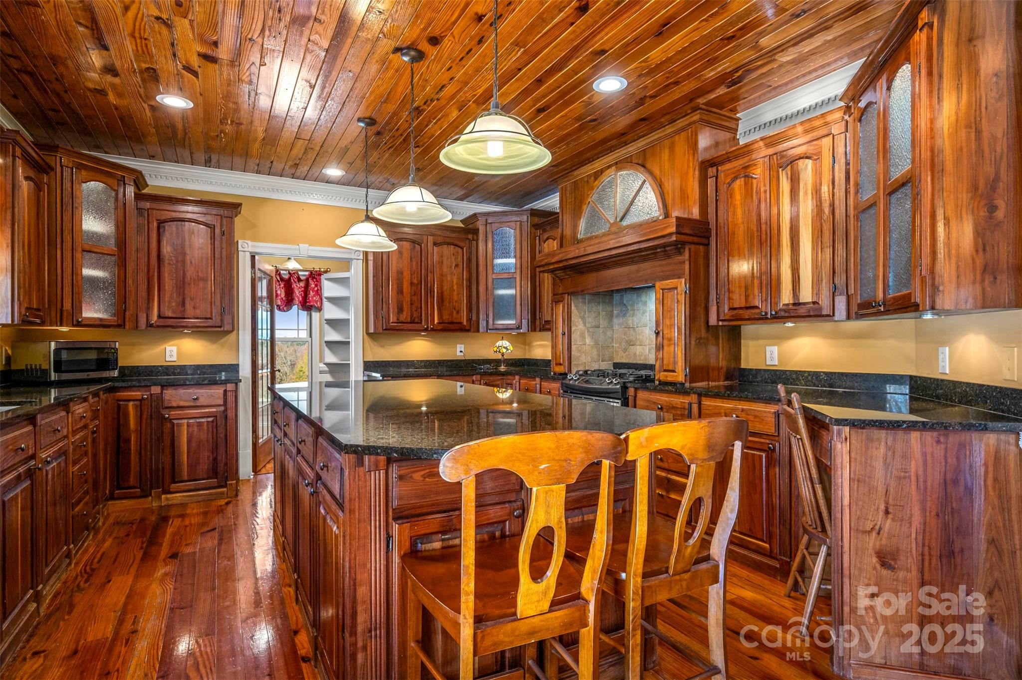 648 Harrill Dairy Road Forest City, NC 28043 - Photo 19 of 47 a large kitchen with lots of wooden cabinets and stainless steel appliances