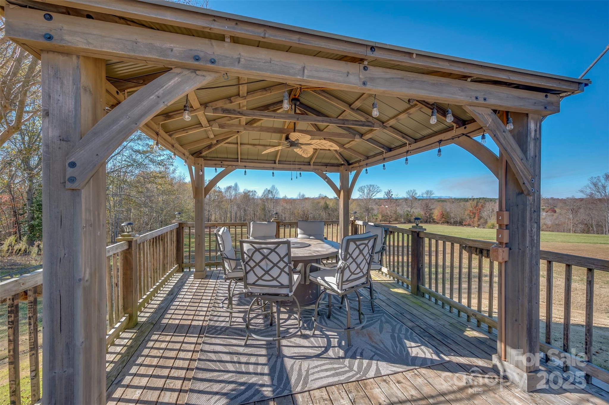 648 Harrill Dairy Road Forest City, NC 28043 - Photo 28 of 47 a patio with wooden floor a yard a table and chairs