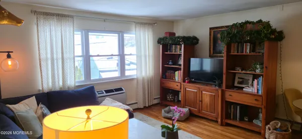a view of a workspace with furniture and a flat screen tv