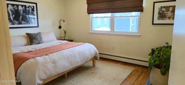 a bedroom with a bed and a potted plant
