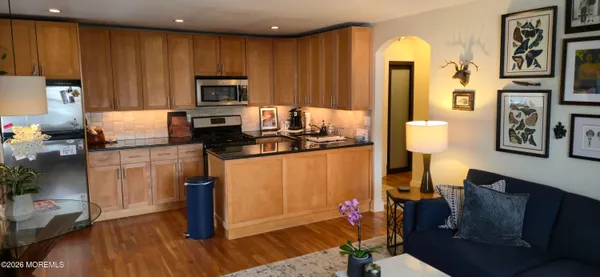 a kitchen with stainless steel appliances granite countertop a refrigerator and a stove top oven