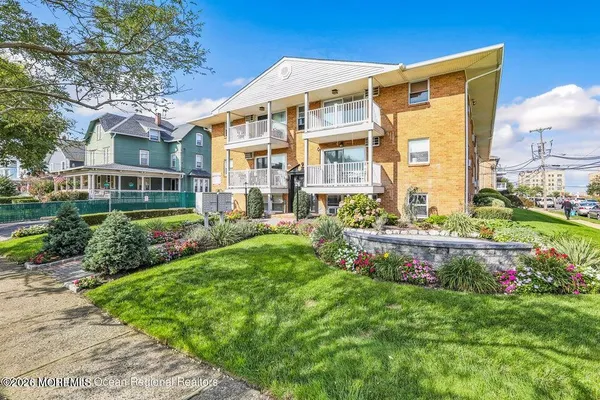 a front view of a house with a yard and outdoor seating