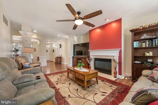 a living room with furniture a fireplace and a flat screen tv