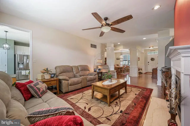 a living room with furniture and a view of kitchen