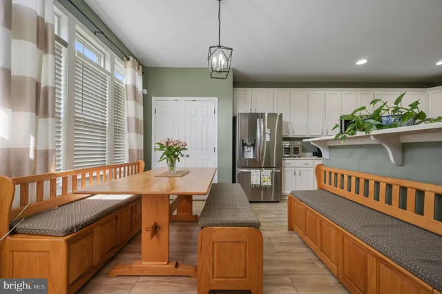 a kitchen with stainless steel appliances granite countertop a refrigerator a stove and a wooden floors