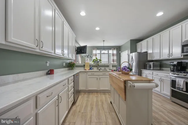 a kitchen with stainless steel appliances granite countertop a sink and cabinets