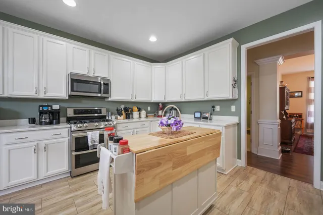 a kitchen with stainless steel appliances granite countertop a stove sink and cabinets