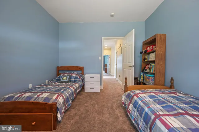 a bedroom with a bed and a large mirror