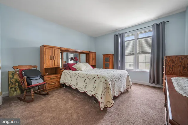 a bed room with a bed and a chair