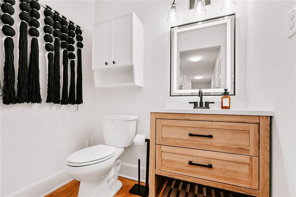 7820 Bethel Road Gainesville, GA 30506 - Photo 12 of 56 a bathroom with a sink a toilet and mirror