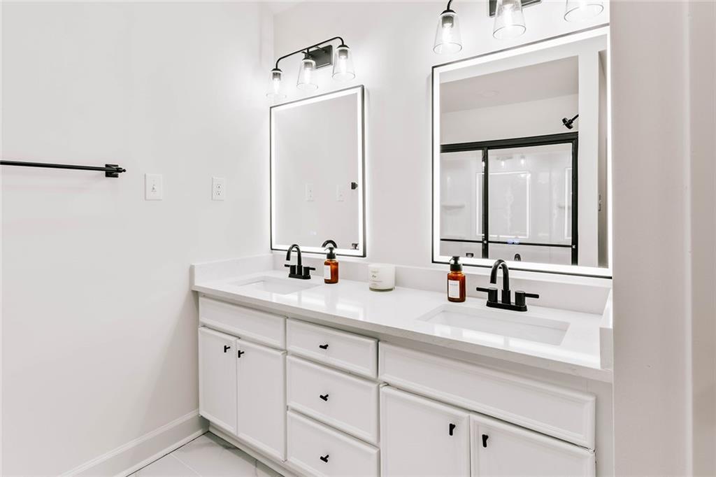 7820 Bethel Road Gainesville, GA 30506 - Photo 20 of 56 a bathroom with a double vanity sink and mirror