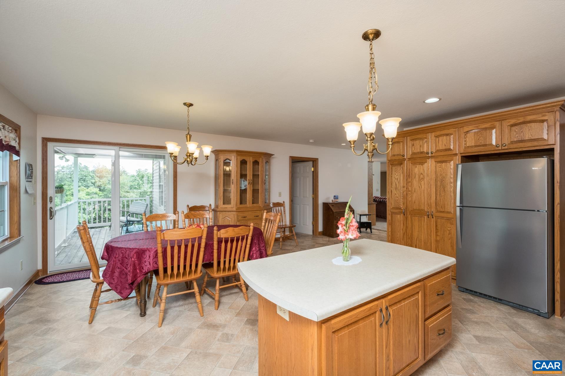 1640 Pea Ridge Road Stanardsville, VA 22973 - Photo 19 of 51 a kitchen with a dining table chairs and chandelier