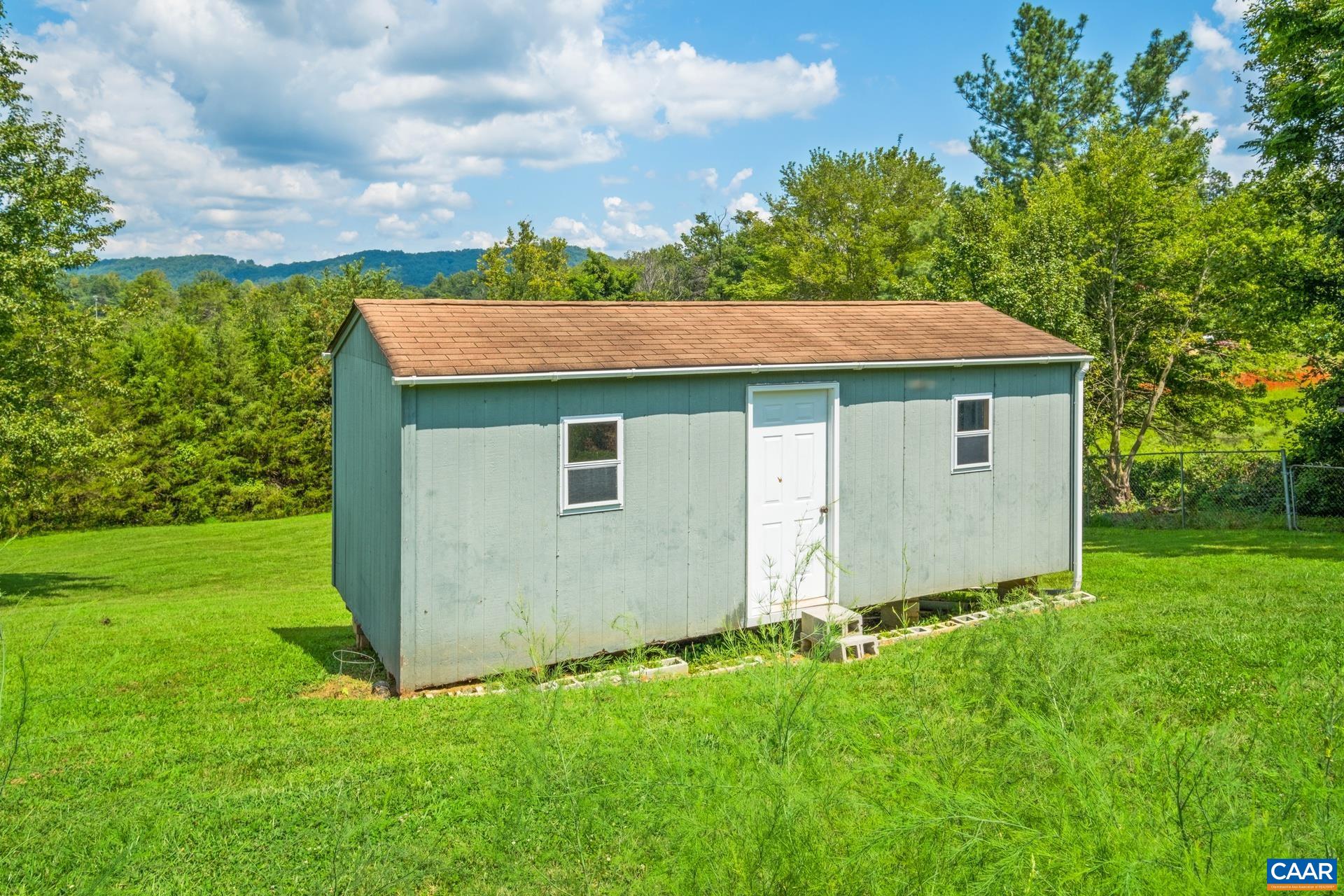 1640 Pea Ridge Road Stanardsville, VA 22973 - Photo 44 of 51 a view of a house with a yard