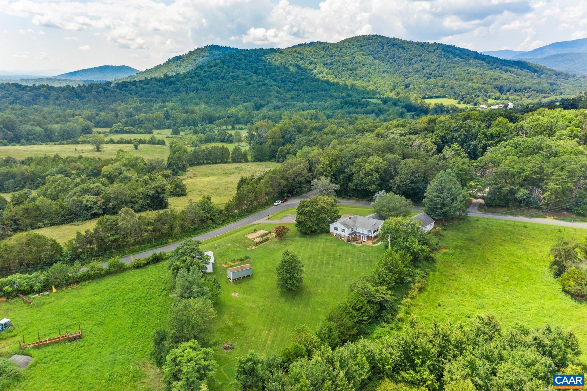 1640 Pea Ridge Road Stanardsville, VA 22973 - Photo 47 of 51 a view of a lush green hillside and a houses