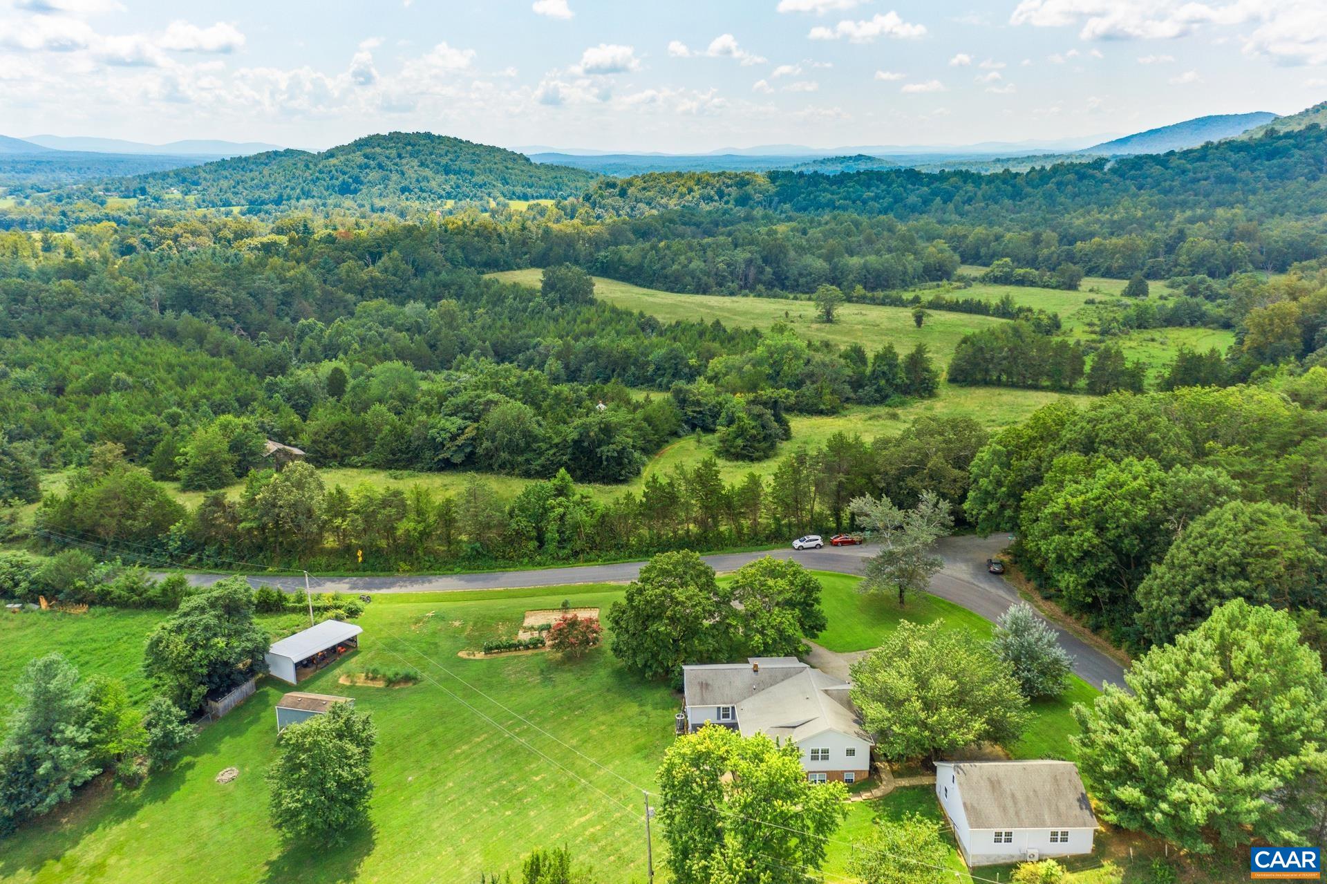 1640 Pea Ridge Road Stanardsville, VA 22973 - Photo 50 of 51 an aerial view of green landscape with trees houses and mountain view