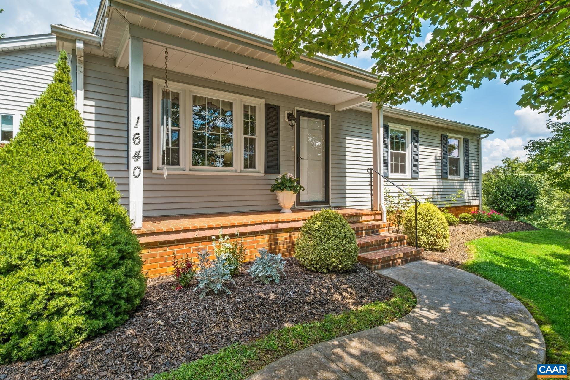 1640 Pea Ridge Road Stanardsville, VA 22973 - Photo 6 of 51 a front view of a house with garden