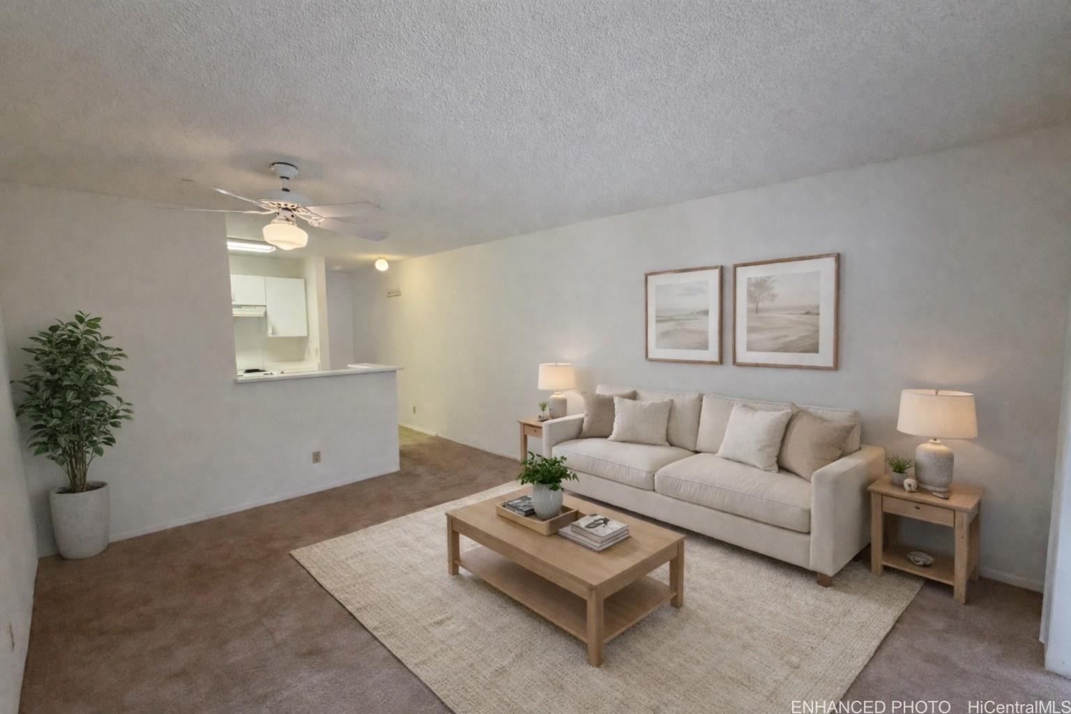 95-510 Wikao Street, Unit Q206 Mililani, HI 96789 - Photo 2 of 19 a living room with furniture and a potted plant