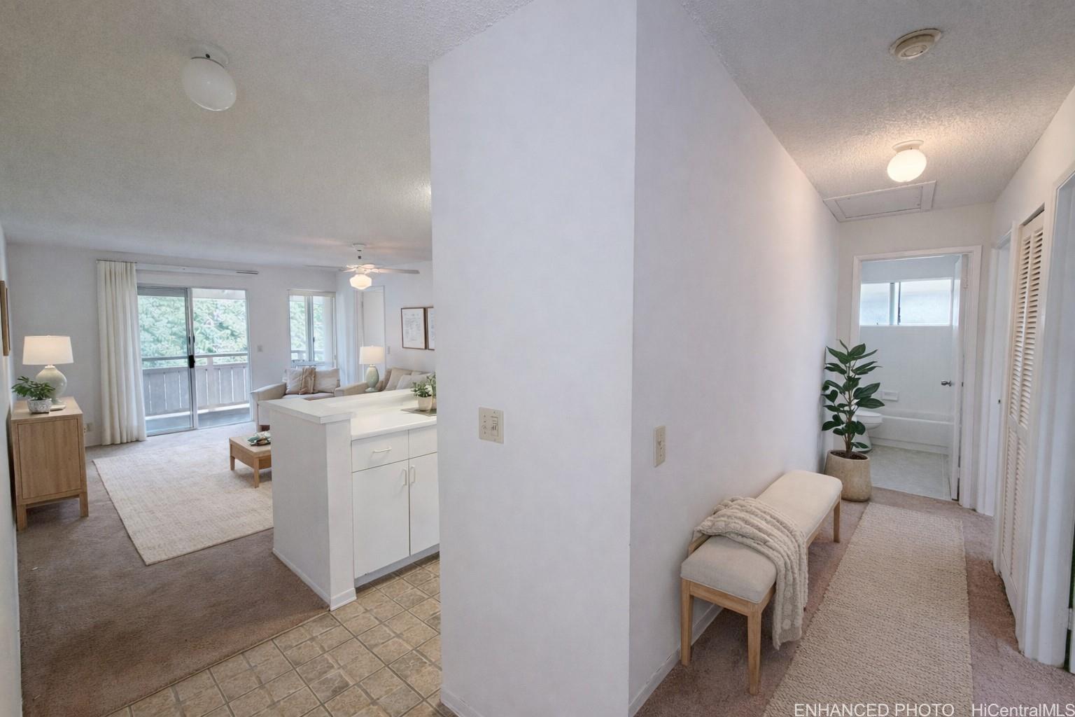 95-510 Wikao Street, Unit Q206 Mililani, HI 96789 - Photo 3 of 19 a living room with furniture and a potted plant