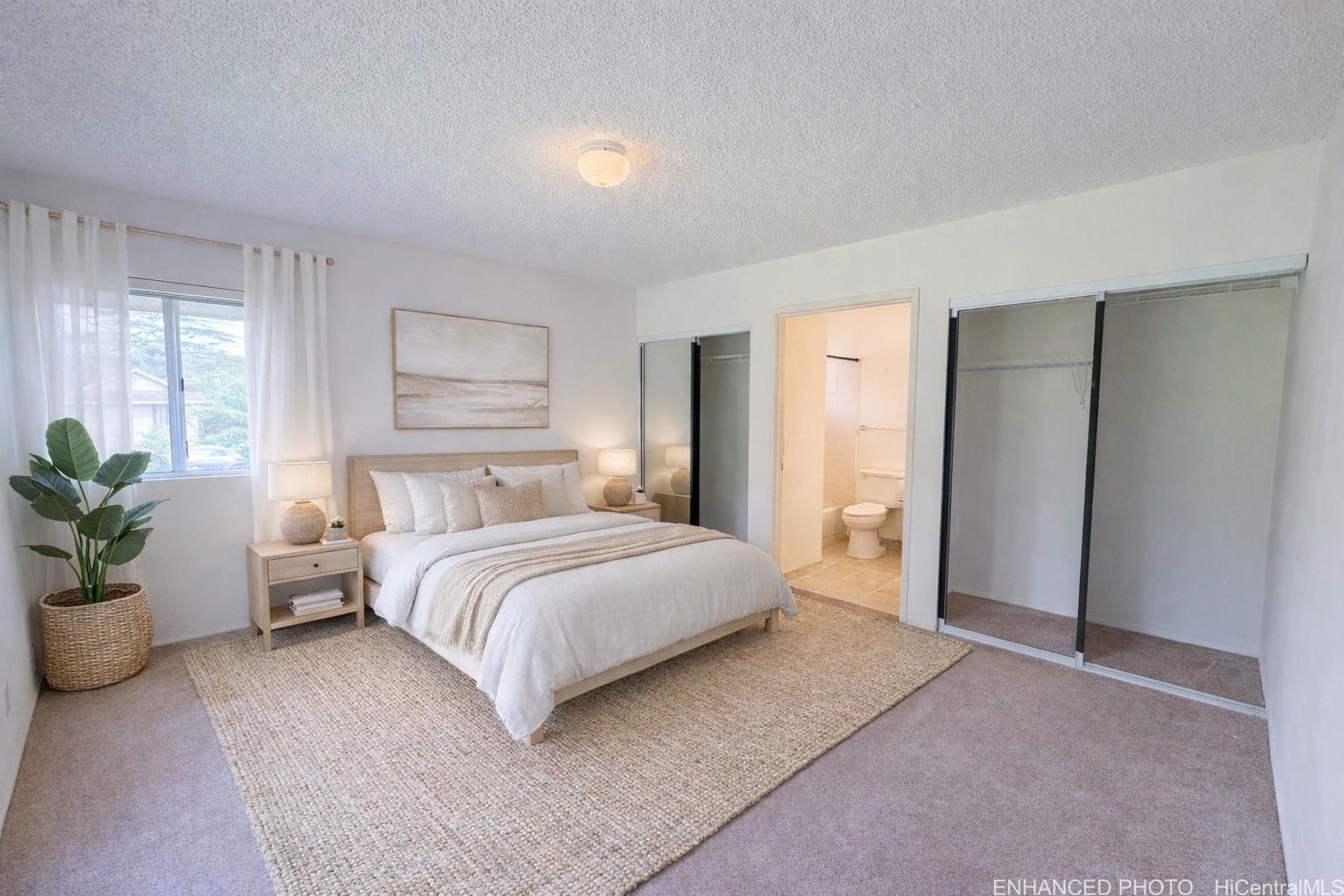 95-510 Wikao Street, Unit Q206 Mililani, HI 96789 - Photo 6 of 19 a spacious bedroom with a bed and a potted plant