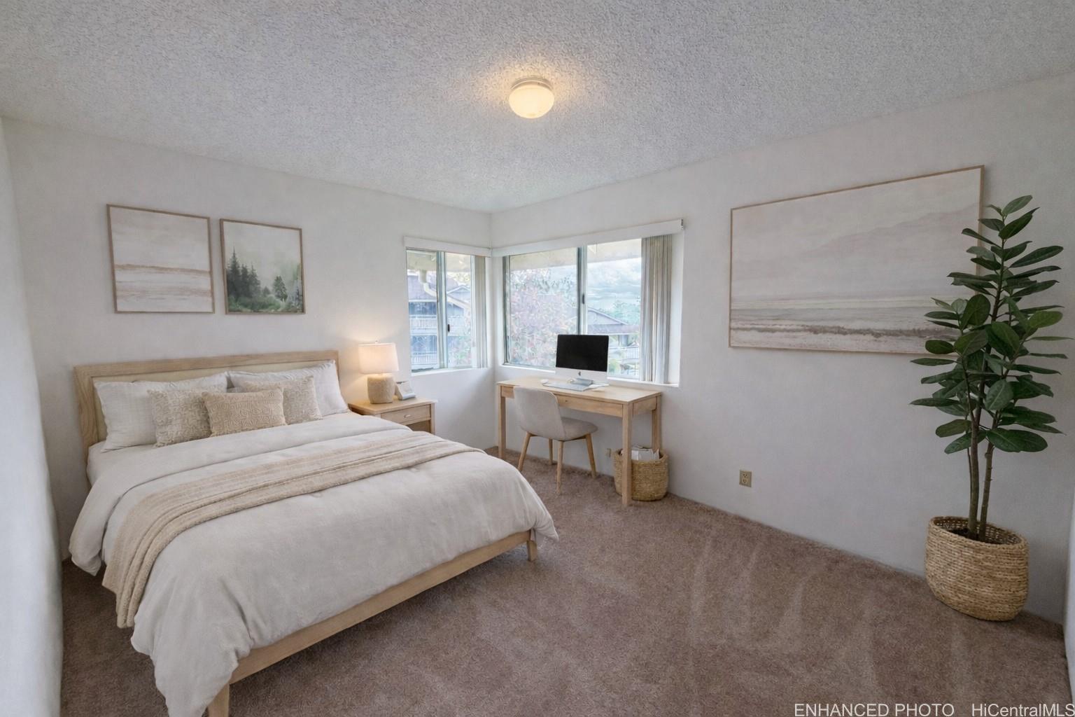 95-510 Wikao Street, Unit Q206 Mililani, HI 96789 - Photo 8 of 19 a bedroom with a bed and a potted plant