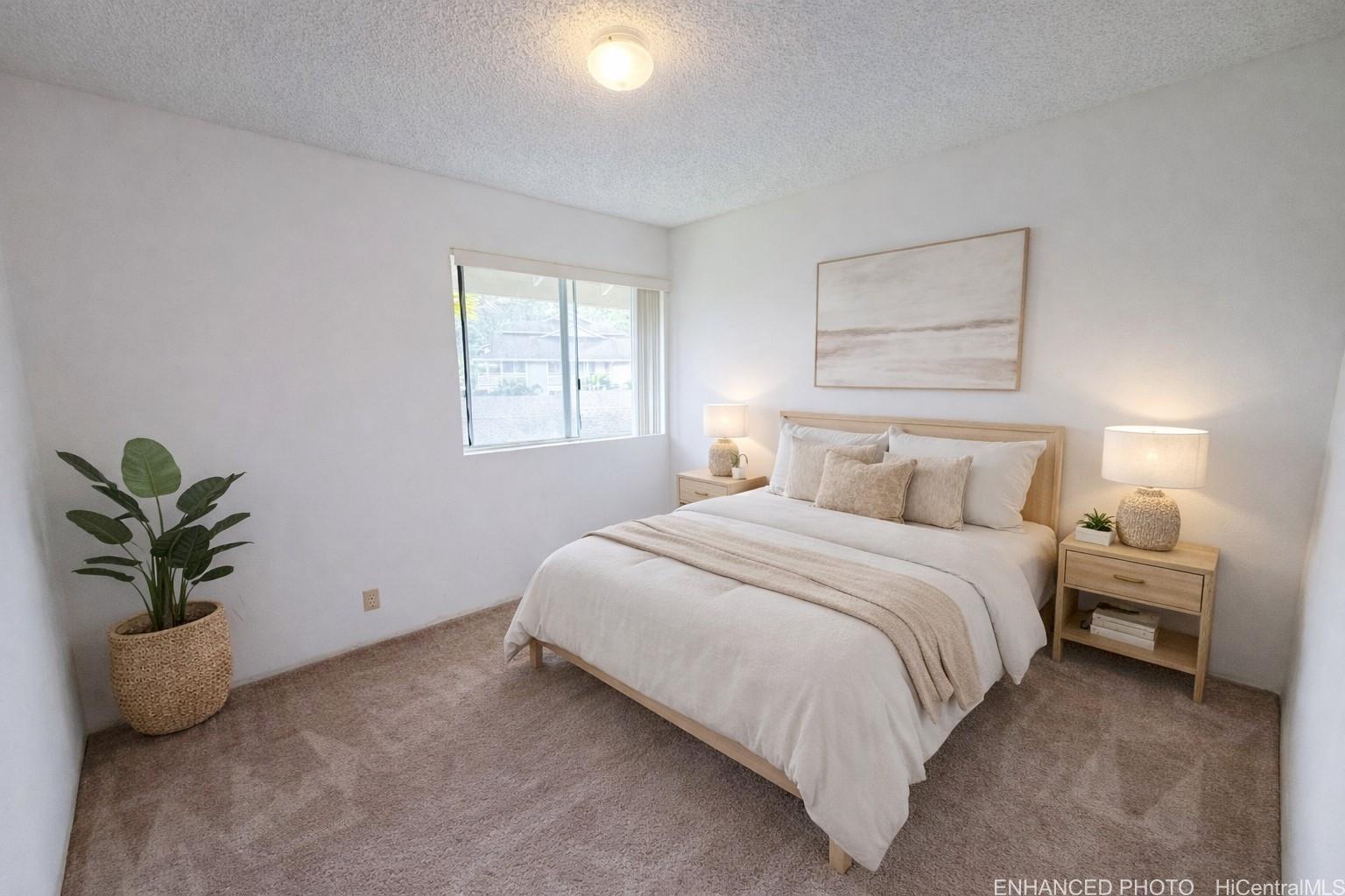 95-510 Wikao Street, Unit Q206 Mililani, HI 96789 - Photo 9 of 19 a bedroom with a bed and a potted plant