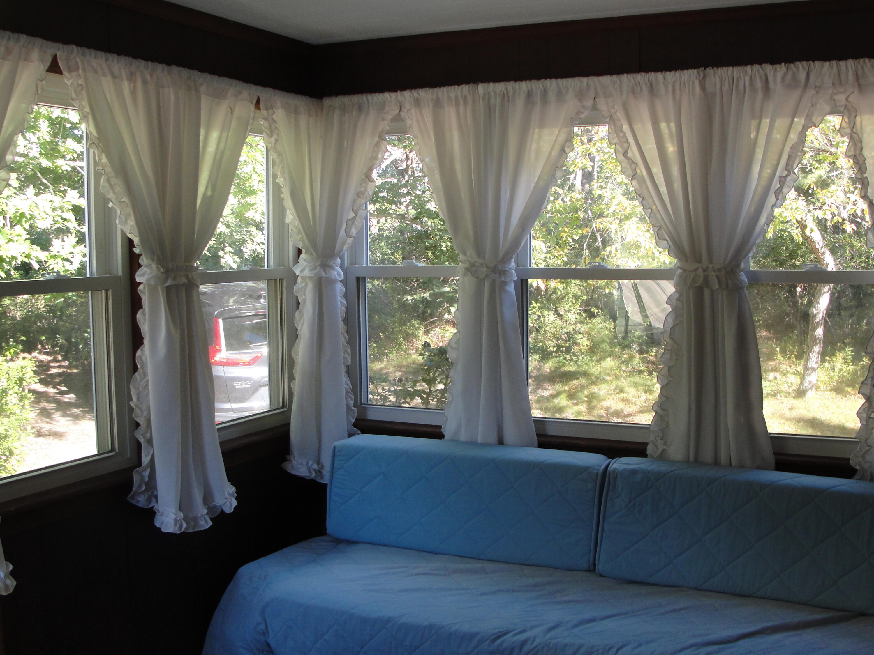 7 E Toms Path Dennis Port, MA 02639 - Photo 15 of 26 a living room with furniture and a large window