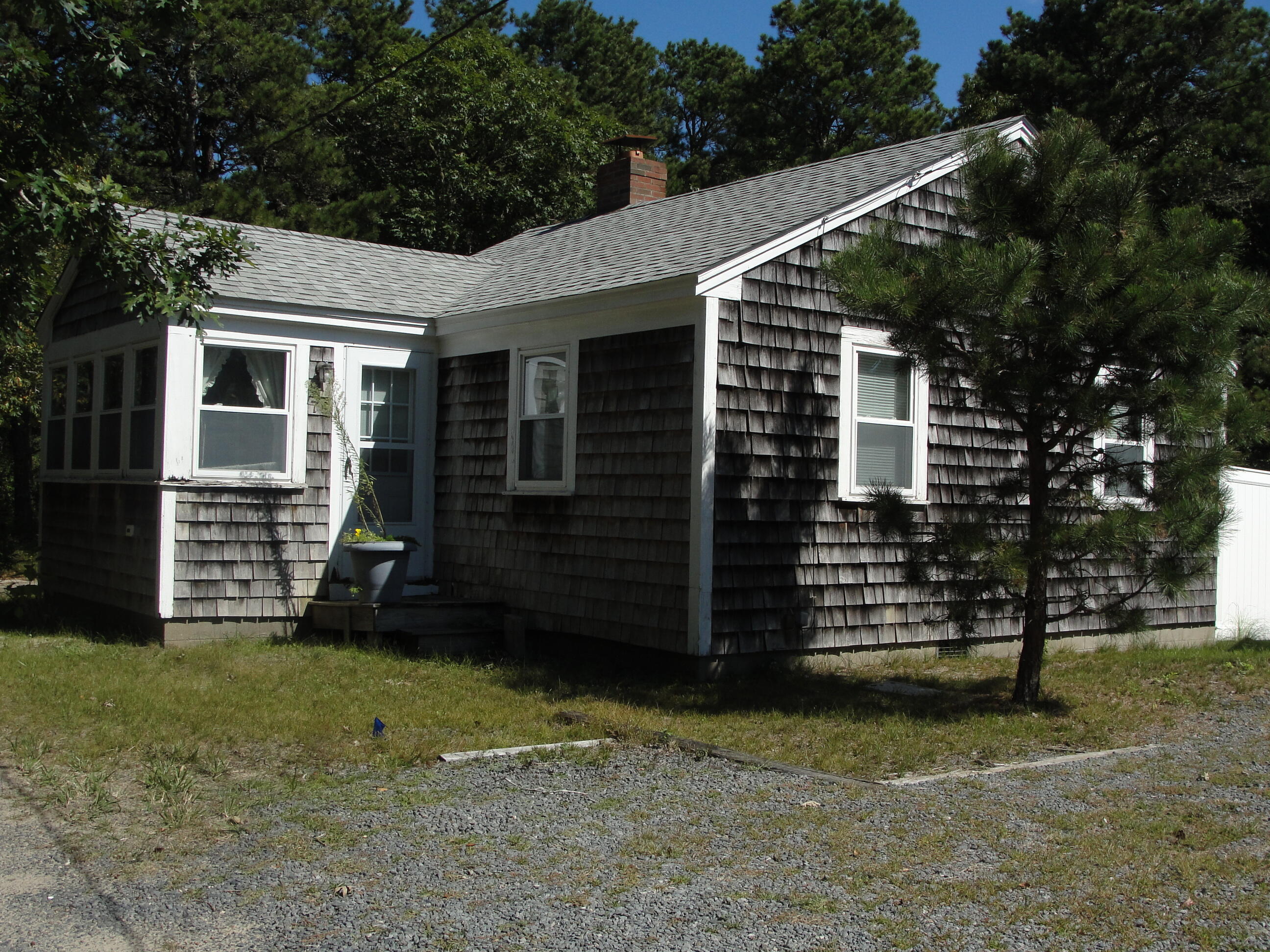 7 E Toms Path Dennis Port, MA 02639 - Photo 17 of 26 a view of a house with a yard
