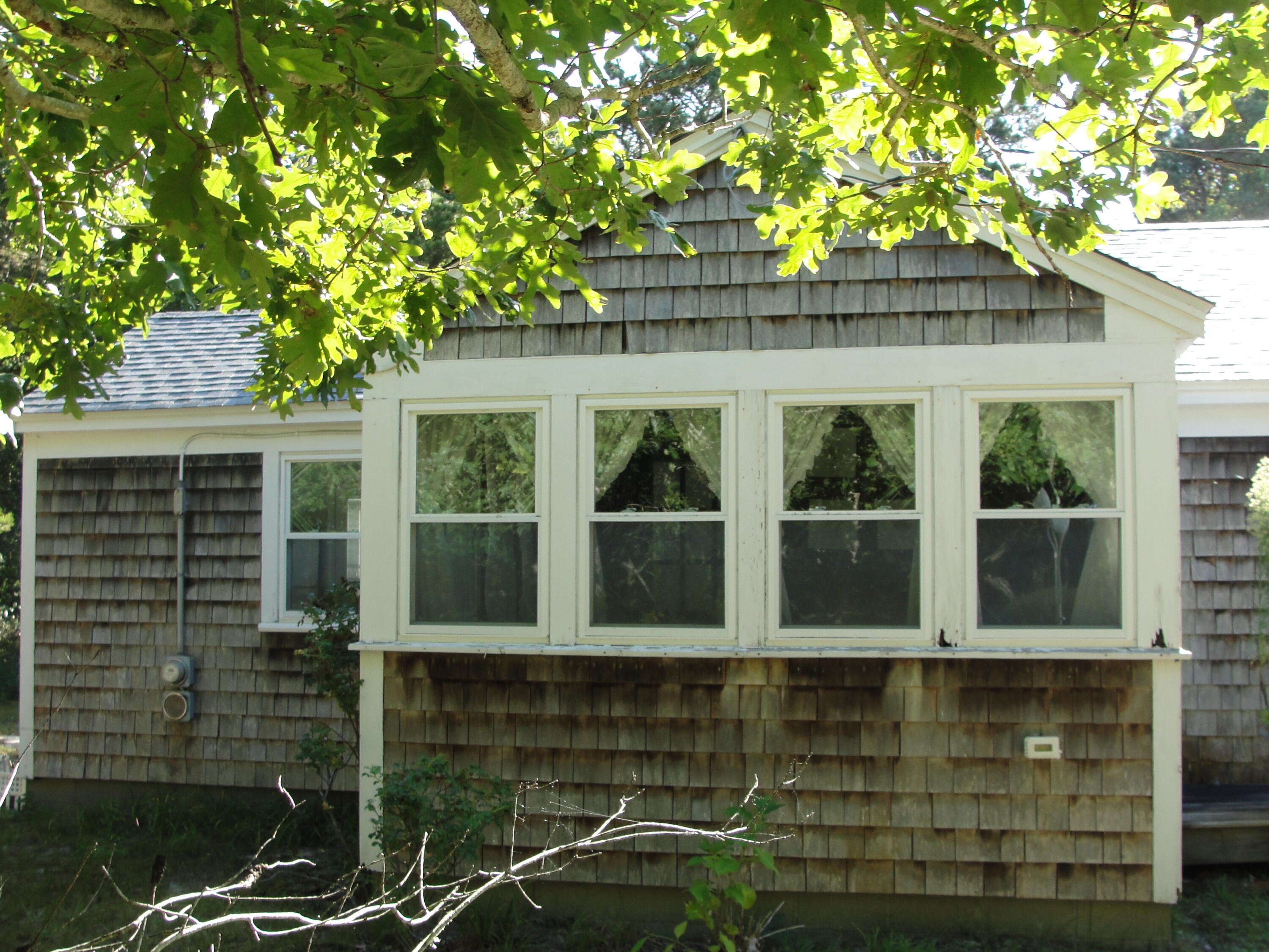 7 E Toms Path Dennis Port, MA 02639 - Photo 25 of 26 a front view of a house with a yard