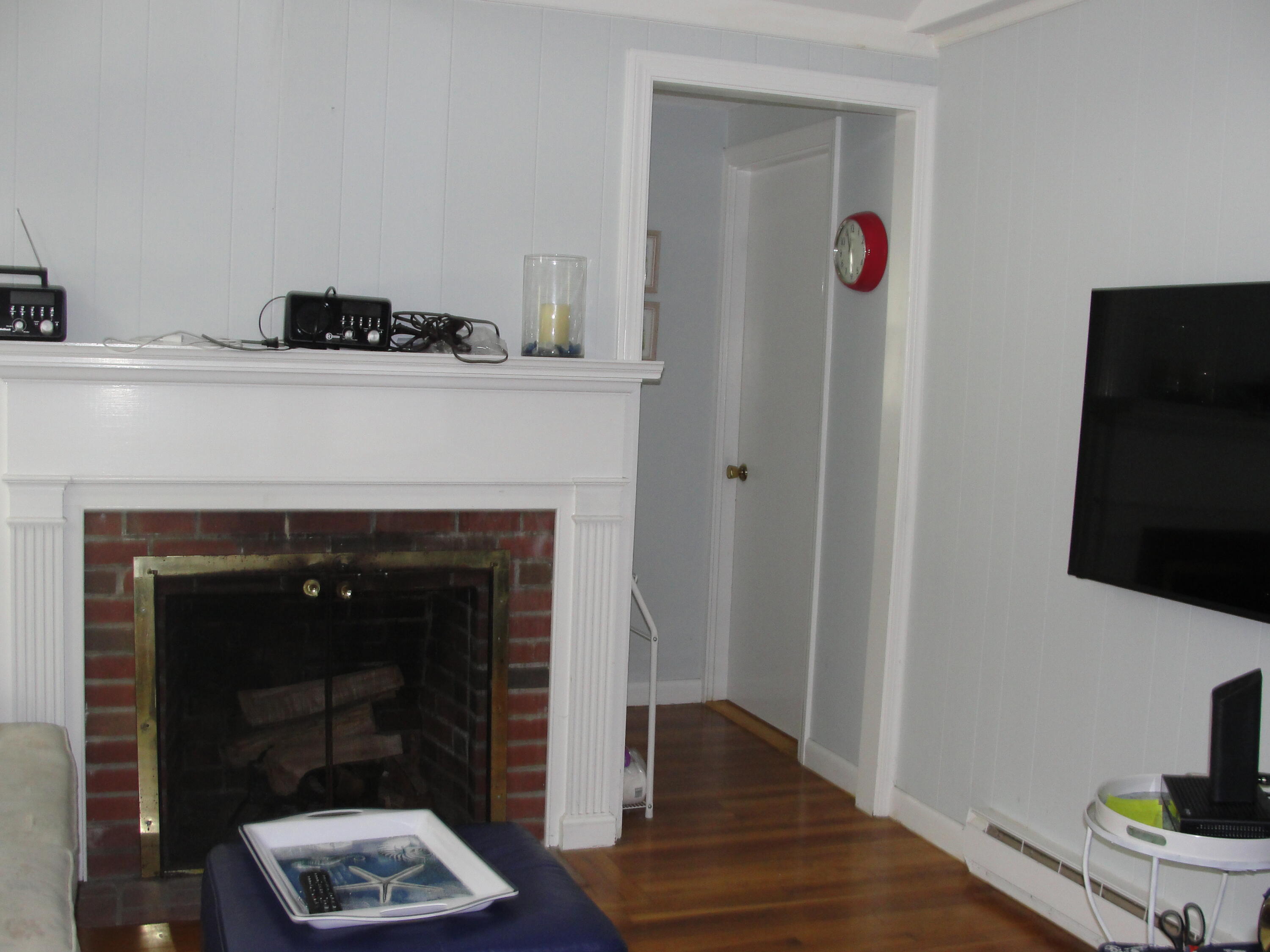 7 E Toms Path Dennis Port, MA 02639 - Photo 4 of 26 a living room with furniture and a fireplace