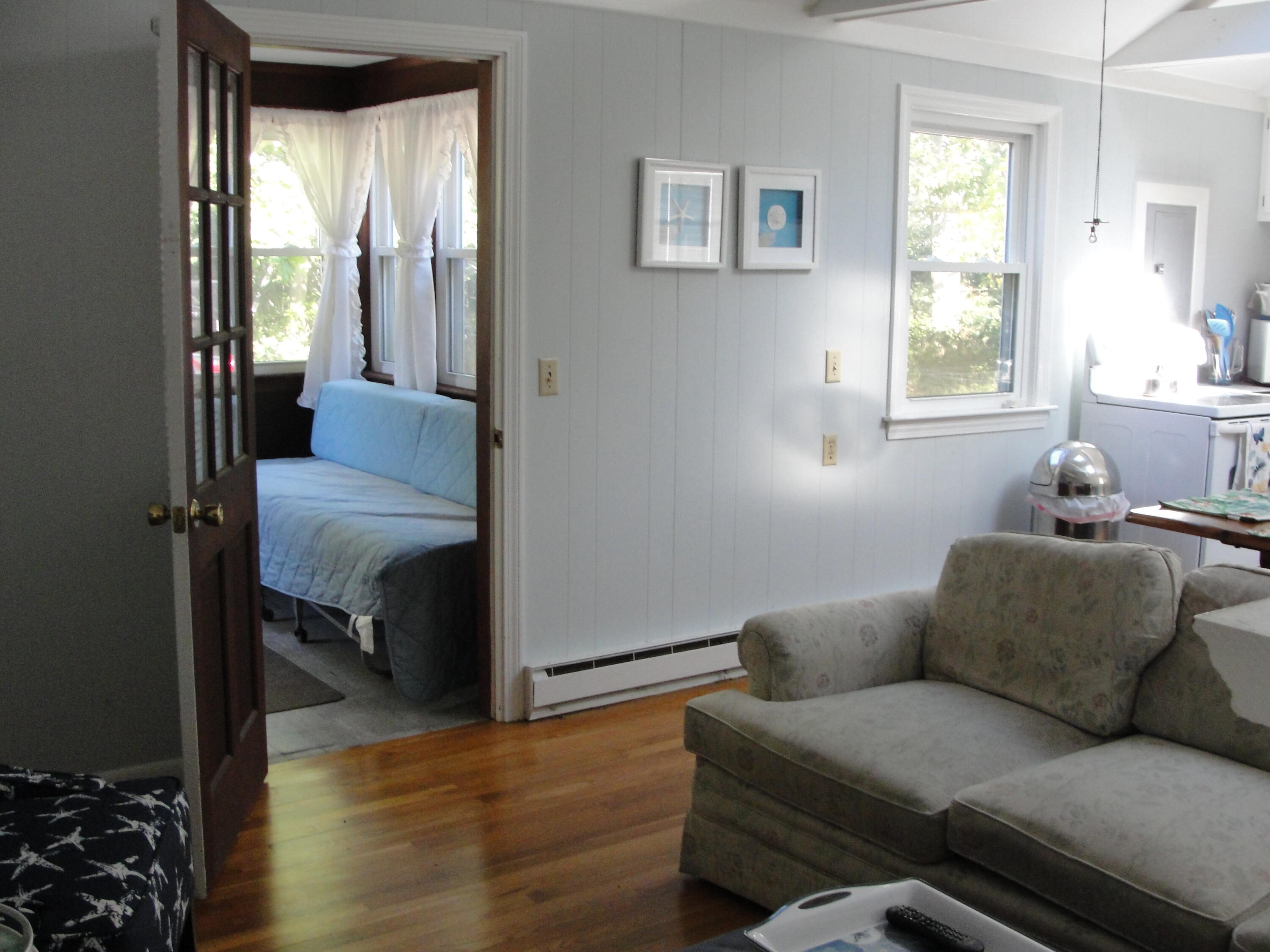 7 E Toms Path Dennis Port, MA 02639 - Photo 6 of 26 a living room with furniture and a window
