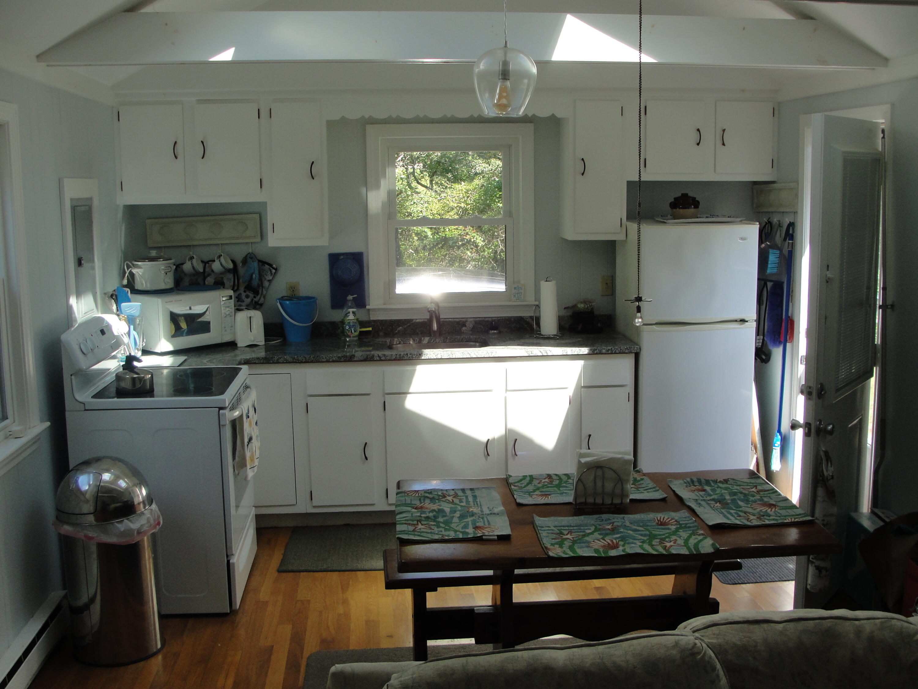 7 E Toms Path Dennis Port, MA 02639 - Photo 8 of 26 a kitchen with stainless steel appliances granite countertop a refrigerator sink and stove
