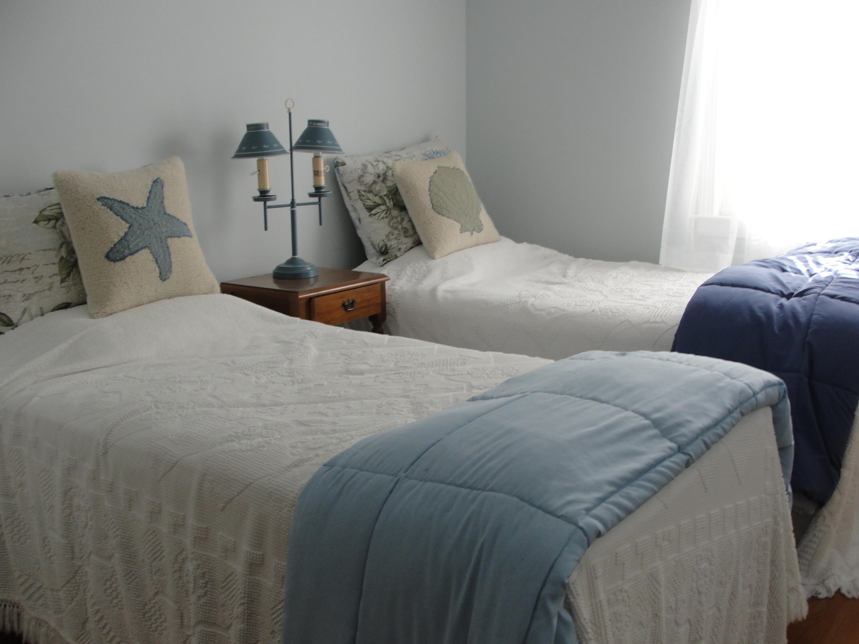 7 E Toms Path Dennis Port, MA 02639 - Photo 9 of 26 a bed room with two bed and a night stand