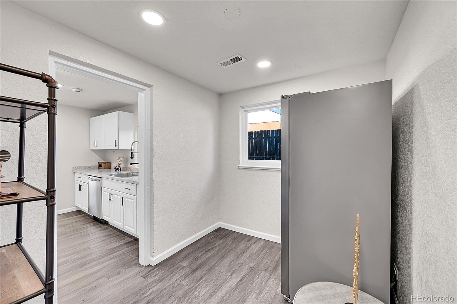 3984 Cook Street Denver, CO 80205 - Photo 13 of 29 a room with white cabinets and wooden floor