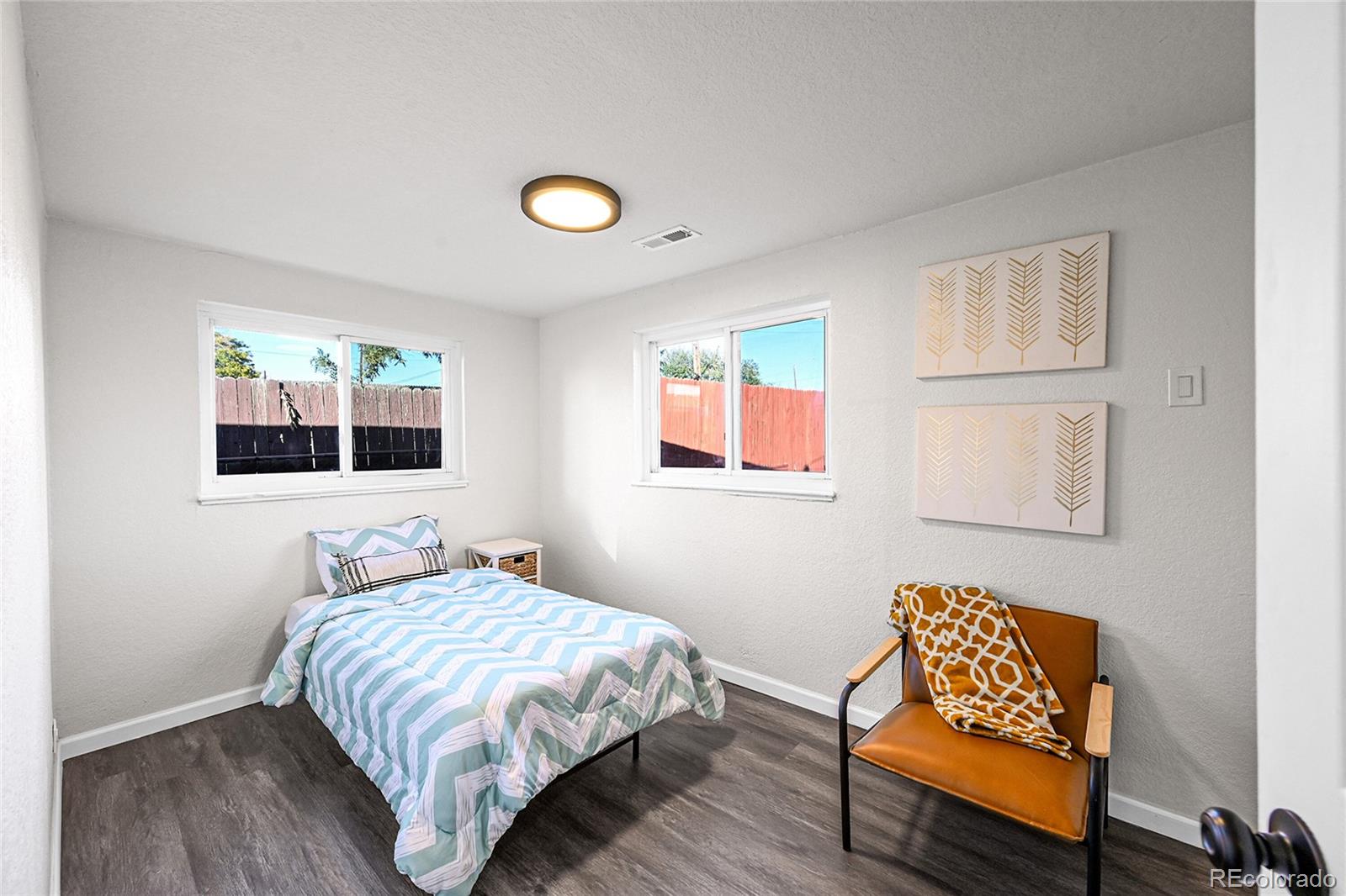 3984 Cook Street Denver, CO 80205 - Photo 14 of 29 a bedroom with a bed and wooden floor