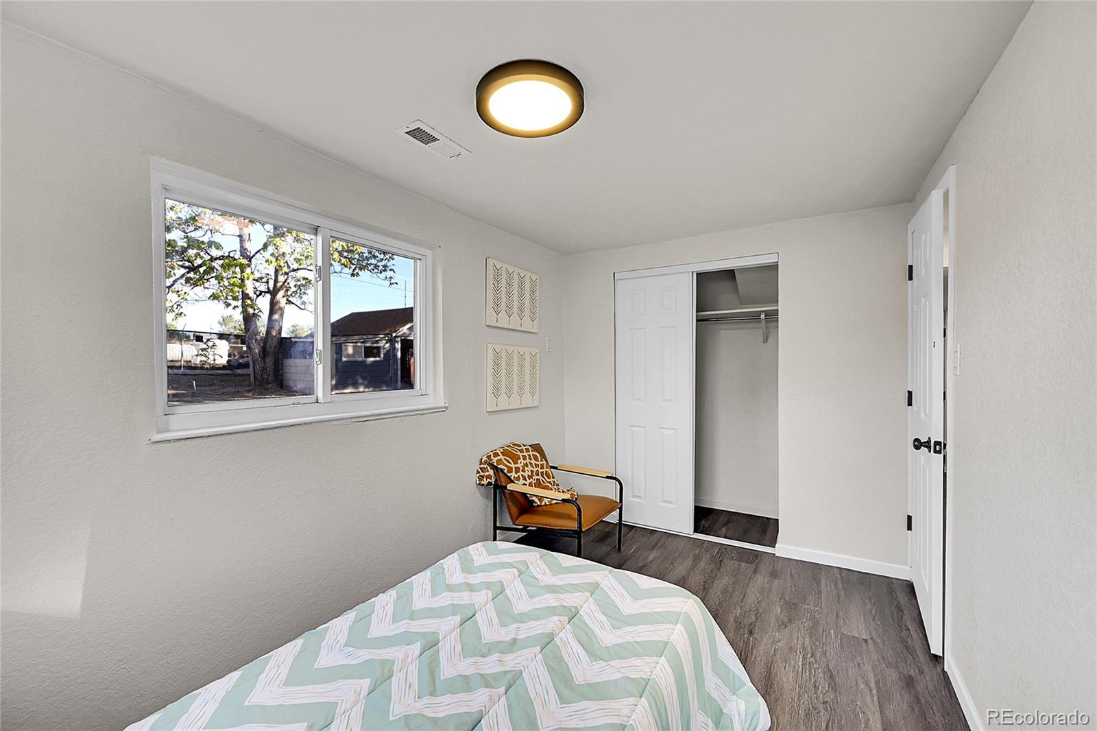 3984 Cook Street Denver, CO 80205 - Photo 16 of 29 a bedroom with a bed and a window