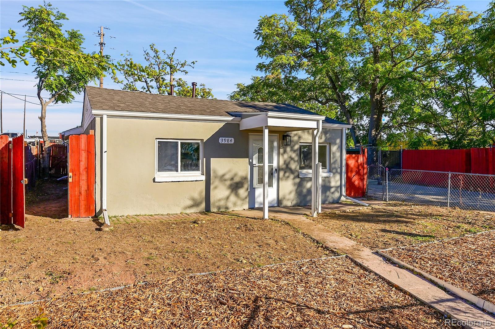 3984 Cook Street Denver, CO 80205 - Photo 27 of 29 a front view of a house with garden