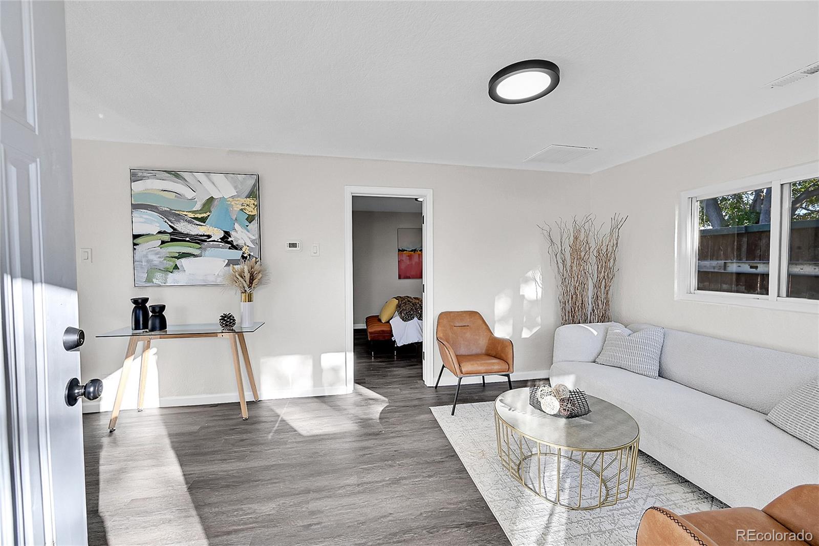 3984 Cook Street Denver, CO 80205 - Photo 5 of 29 a living room with furniture and wooden floor