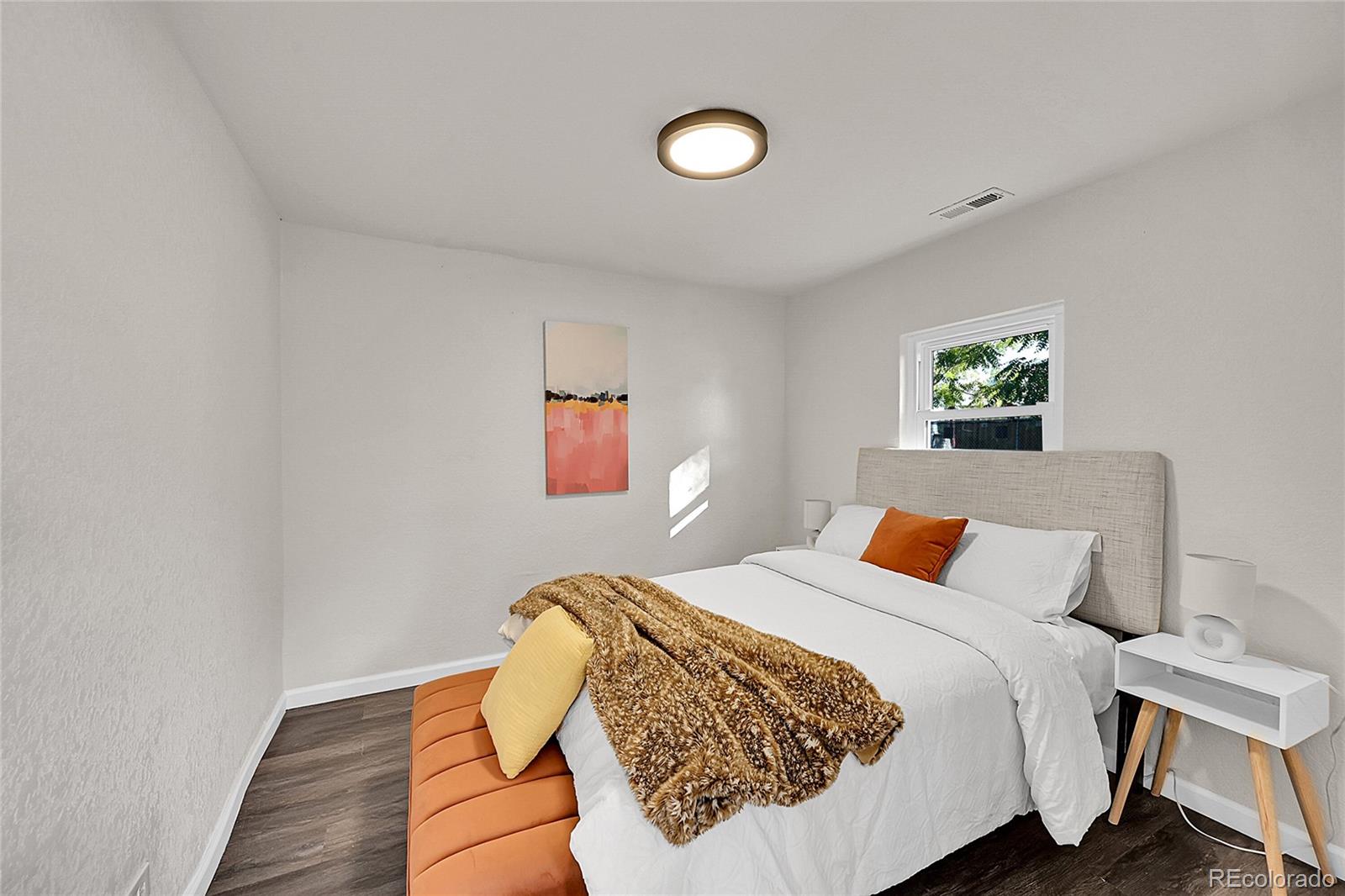 3984 Cook Street Denver, CO 80205 - Photo 9 of 29 a bedroom with a bed and a painting on the wall