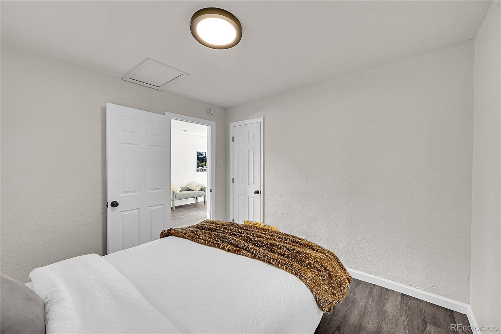 3984 Cook Street Denver, CO 80205 - Photo 10 of 29 a bedroom with a bed and a cabinets