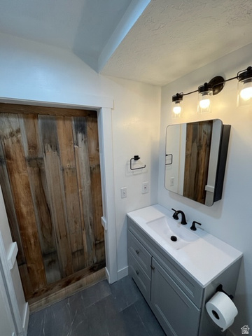 6884 670 East Midvale, UT 84047 - Photo 13 of 28 Bathroom with vanity and a textured ceiling