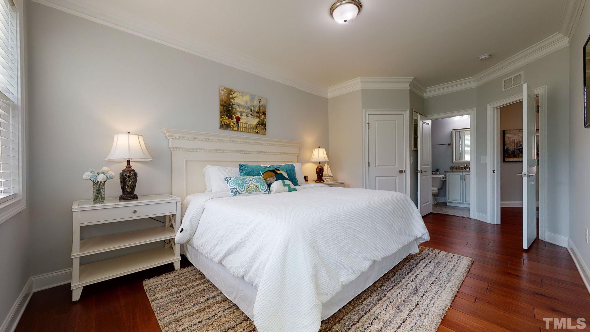 2351 Terrmini Drive Apex, NC 27502 - Photo 14 of 30 a spacious bedroom with a bed and wooden floor