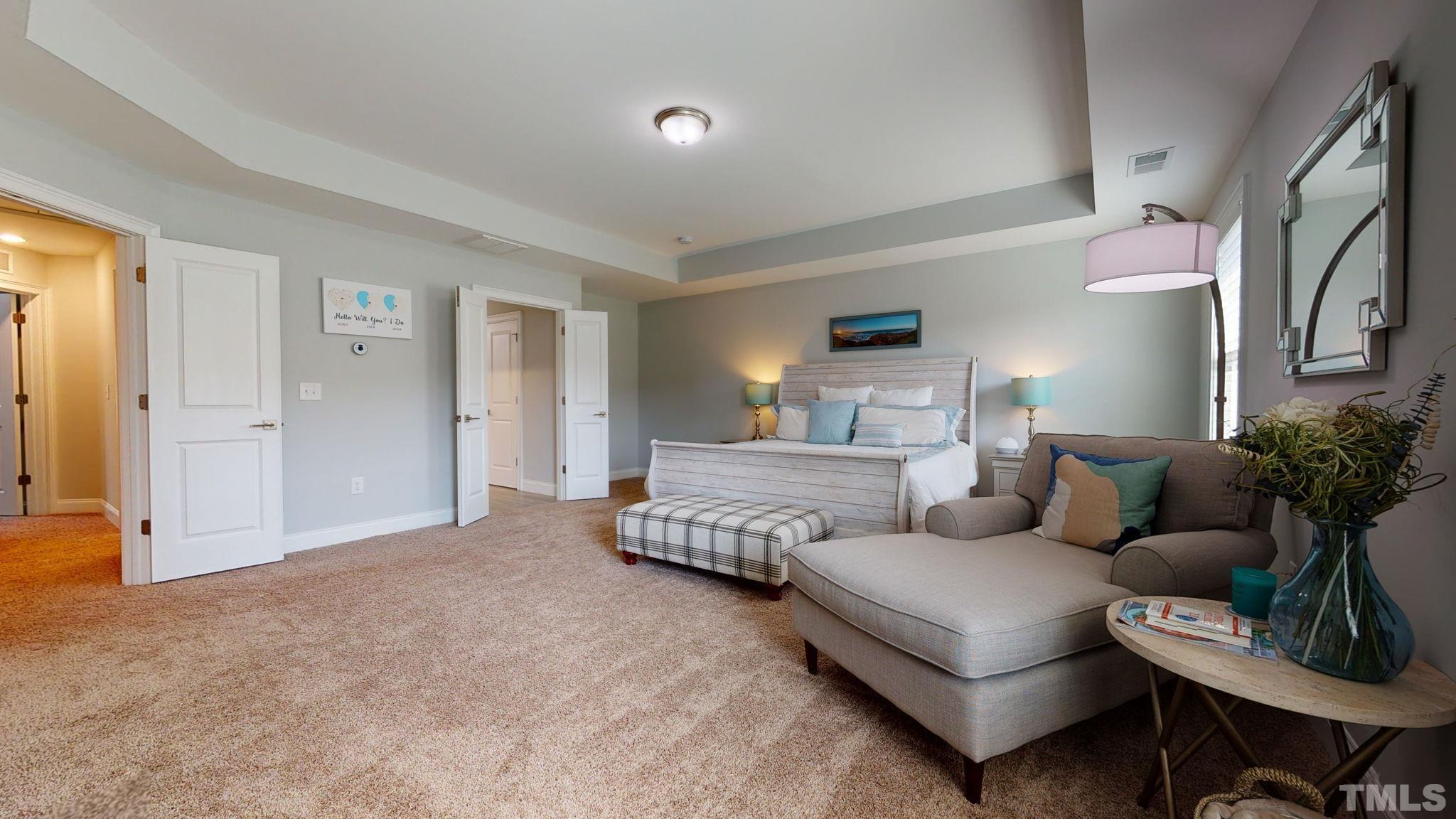 2351 Terrmini Drive Apex, NC 27502 - Photo 16 of 30 a bedroom with furniture and a couch