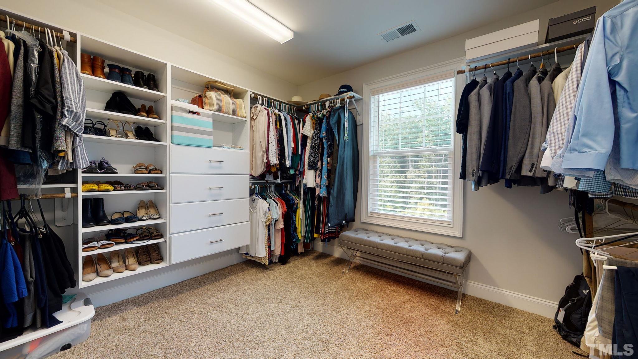 2351 Terrmini Drive Apex, NC 27502 - Photo 20 of 30 a view of walk in closet with clothes and shoes