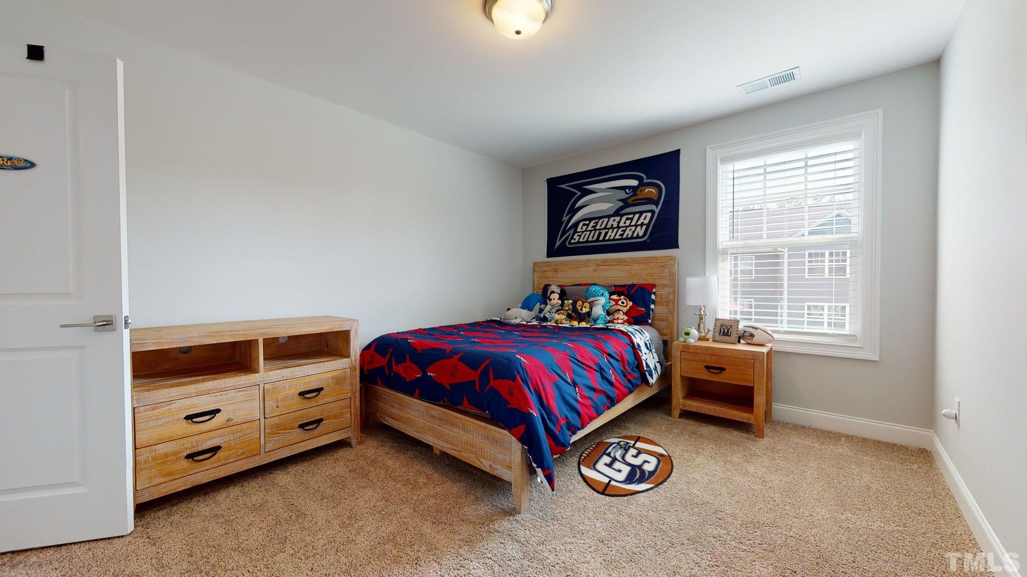 2351 Terrmini Drive Apex, NC 27502 - Photo 22 of 30 a bed room with a bed and a window